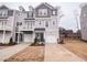 New construction townhome with a one car garage and gray wood siding at 203 Pond Vw Ct # 1, Fuquay Varina, NC 27526