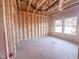 Spacious room with a large window in a home under construction with wooden framing at 203 Pond Vw Ct # 1, Fuquay Varina, NC 27526