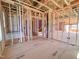 Bright, unfinished living room showcasing stairs, wooden framework, and exposed ceiling at 203 Pond Vw Ct # 1, Fuquay Varina, NC 27526