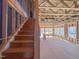 View of unfinished wood stairs with view of the living room and multiple windows at 203 Pond Vw Ct # 1, Fuquay Varina, NC 27526