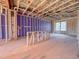 Interior view of framing; potential living room showcasing the start of a well-lit space with large windows at 205 Pond Vw Ct # 2, Fuquay Varina, NC 27526