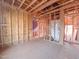 The interior under construction reveals exposed framing, plumbing, and electrical work throughout the spacious room at 205 Pond Vw Ct # 2, Fuquay Varina, NC 27526