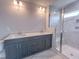 Modern bathroom featuring double vanity, sleek fixtures, and a glass-enclosed shower at 207 Pond View Ct # 3, Fuquay Varina, NC 27526