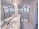 Elegant bathroom with dual sinks, a large mirror, and a glass-enclosed shower at 207 Pond View Ct # 3, Fuquay Varina, NC 27526