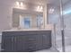 Bathroom featuring double vanity, shower with glass door and marble-look tile at 207 Pond View Ct # 3, Fuquay Varina, NC 27526