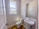 Cozy half bath with a pedestal sink, a window, wood floors, and natural light at 207 Pond View Ct # 3, Fuquay Varina, NC 27526