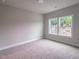 Neutral bedroom with new carpeting and natural light from two windows at 207 Pond View Ct # 3, Fuquay Varina, NC 27526