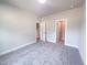 Bedroom featuring neutral carpeting with open doorway to hallway and closet at 207 Pond View Ct # 3, Fuquay Varina, NC 27526