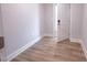 A bright, empty bedroom is shown with light wood floors and a white door slightly open at 207 Pond View Ct # 3, Fuquay Varina, NC 27526
