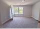Cozy bedroom featuring neutral walls, plush carpeting, and windows with natural light at 207 Pond View Ct # 3, Fuquay Varina, NC 27526