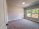 Cozy bedroom with plush carpeting, large windows, and neutral paint at 207 Pond View Ct # 3, Fuquay Varina, NC 27526