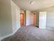 Spacious bedroom featuring neutral walls, plush carpeting, and multiple doors at 207 Pond View Ct # 3, Fuquay Varina, NC 27526