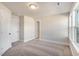 Neutral bedroom with carpet, window, and doors at 207 Pond View Ct # 3, Fuquay Varina, NC 27526