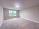 Bright bedroom with plush carpet and a large window offering plenty of natural light at 207 Pond View Ct # 3, Fuquay Varina, NC 27526