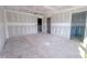 Open bedroom highlighting pre-paint construction, showing multiple entryways and ample natural light potential at 207 Pond View Ct # 3, Fuquay Varina, NC 27526
