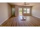 Bright bedroom features hardwood floors, a ceiling fan, deck access, and an interior door at 207 Pond View Ct # 3, Fuquay Varina, NC 27526