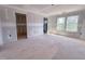 Spacious bedroom area with natural light, showcasing the construction phase with drywall and window views at 207 Pond View Ct # 3, Fuquay Varina, NC 27526