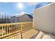Exterior view of the wooden deck, showcasing the home's siding and neighboring houses at 207 Pond View Ct # 3, Fuquay Varina, NC 27526