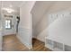 Spacious entryway featuring hardwood floors, and a built-in bench with coat hooks at 207 Pond View Ct # 3, Fuquay Varina, NC 27526