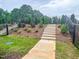 Landscaped community path with stairs and black metal fencing at 207 Pond View Ct # 3, Fuquay Varina, NC 27526