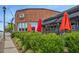 Charming exterior of The Meeting Place Tavern featuring a brick facade, colorful umbrellas, and sidewalk seating at 207 Pond View Ct # 3, Fuquay Varina, NC 27526
