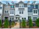 Charming townhouse with a well-manicured lawn and black metal fence at 207 Pond View Ct # 3, Fuquay Varina, NC 27526