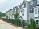 A row of townhouses with different colors and black fences at 207 Pond View Ct # 3, Fuquay Varina, NC 27526