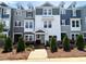 Charming new townhome exterior with colorful facade, dormer windows, and landscaped front yard at 207 Pond View Ct # 3, Fuquay Varina, NC 27526