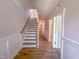Bright hallway featuring stairs, neutral walls, and wood-look flooring at 207 Pond View Ct # 3, Fuquay Varina, NC 27526