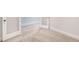 View of a hallway and doorway showcasing neutral carpeted flooring and modern baseboards at 207 Pond View Ct # 3, Fuquay Varina, NC 27526