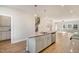 Kitchen island featuring a stainless-steel dishwasher that flows into the living area with great natural light at 207 Pond View Ct # 3, Fuquay Varina, NC 27526