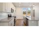 Bright kitchen featuring sleek stainless steel appliances, granite countertops, and ample cabinet space at 207 Pond View Ct # 3, Fuquay Varina, NC 27526