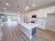 Open floor plan with an island kitchen, stainless steel appliances, and access to the deck at 207 Pond View Ct # 3, Fuquay Varina, NC 27526