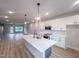 Open floor plan shows the kitchen with island, and the living room with outdoor access at 207 Pond View Ct # 3, Fuquay Varina, NC 27526
