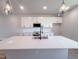Modern kitchen with stainless steel appliances, white cabinets, backsplash, and stylish pendant lights at 207 Pond View Ct # 3, Fuquay Varina, NC 27526