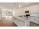 Open concept living area connecting a modern kitchen island with stainless steel sink to the living room at 207 Pond View Ct # 3, Fuquay Varina, NC 27526