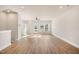 Bright, open living room with hardwood floors, ceiling fan, and natural light from the outdoor access at 207 Pond View Ct # 3, Fuquay Varina, NC 27526