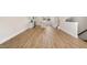 Spacious room featuring hardwood floors, staircase access, and an open layout connected to the kitchen at 207 Pond View Ct # 3, Fuquay Varina, NC 27526