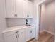 Bright mudroom with white cabinetry, stylish backsplash, and convenient sink area at 207 Pond View Ct # 3, Fuquay Varina, NC 27526