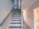 White staircase with wooden handrail next to hallway leading to bathroom at 207 Pond View Ct # 3, Fuquay Varina, NC 27526