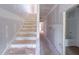 View of a staircase next to hallway, ready for flooring and design finishes at 207 Pond View Ct # 3, Fuquay Varina, NC 27526