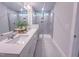 Bathroom with double vanity, quartz countertop, and glass-enclosed tiled shower at 209 Pond View Ct # 4, Fuquay Varina, NC 27526