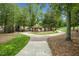 Community park features a gazebo, lush lawns, and paved walkways under a canopy of mature trees at 209 Pond View Ct # 4, Fuquay Varina, NC 27526