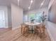Bright dining area with modern lighting, round table and chairs with a view to the outdoor space at 209 Pond View Ct # 4, Fuquay Varina, NC 27526