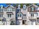 Charming townhome with neutral siding, dormer windows, and convenient attached garages at 209 Pond View Ct # 4, Fuquay Varina, NC 27526