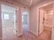 Hallway with doorways leading to bedrooms and a bathroom with a shower-tub combo at 209 Pond View Ct # 4, Fuquay Varina, NC 27526