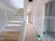 Hallway with staircase, showcasing the home's layout and flow at 209 Pond View Ct # 4, Fuquay Varina, NC 27526