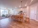 Modern kitchen with large island, pendant lighting, white cabinets, and stainless steel appliances open to living room at 209 Pond View Ct # 4, Fuquay Varina, NC 27526