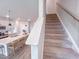 View of the carpeted stairs leading up from the kitchen with island seating and pendant lighting at 209 Pond View Ct # 4, Fuquay Varina, NC 27526