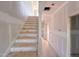 Unfinished staircase with protective coverings, leading to the upper level and awaiting final design elements at 209 Pond View Ct # 4, Fuquay Varina, NC 27526